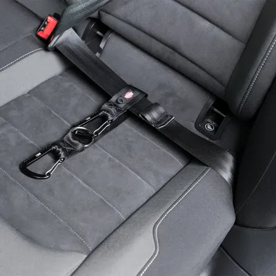 Black safety belt with carabiner hook, attached to a car seat with ISOFIX system.