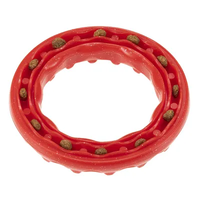 Red rubber ring with embedded dry food pieces in the grooves.