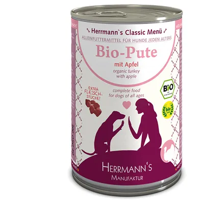 Herrmann's Classic Menü Bio-Pute mit Apfel, compleet hondenvoer met stukjes vlees. Bio-keurmerk zichtbaar. Tekst: complete food for dogs of all ages, Herrmann's Manufaktur.