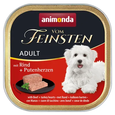 Animonda Vom Feinsten Adult mit Rind und Putenherzen. Serviervorschlag: Fleischstück auf schwarzem Teller, Hund abgebildet. Produkt für Erwachsene.
