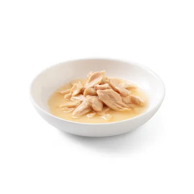 Skål med möra bitar av kycklingkött i ljus sås, lämplig för att visa produktinnehåll eller konsistens.