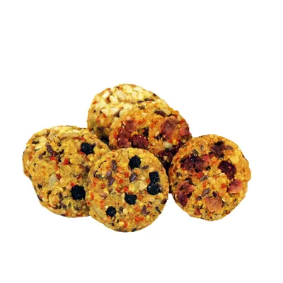 Round snacks with visible ingredients such as grains, fruits and seeds. Colourful mix of yellow, red and black.