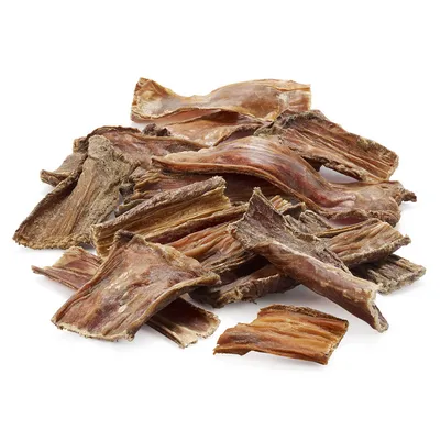 Pile of dried meat strips displayed on a white background, showing the product’s texture and size for treat or snack use.