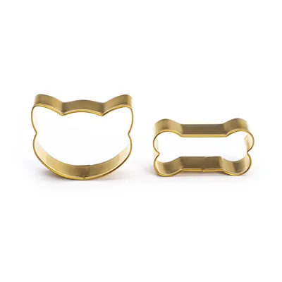 Two gold-coloured cookie cutters: one in cat head shape, the other in bone shape. Suitable for biscuits or crafts.