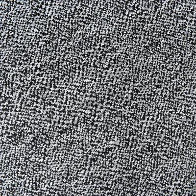 Primo piano di una texture bianca e nera, possibilmente tessuto o materiale per tappeti.
