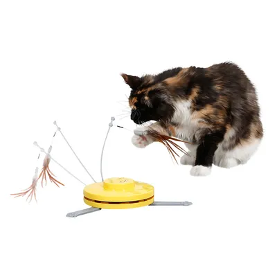 Toy with yellow base and movable feathers, actively used by a cat.