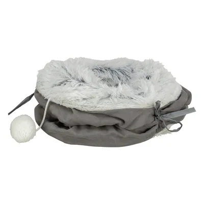 Graues, rundes Kuschelbett mit weichem, weissem Kunstfellrand und dekorativer Kordel. Enthält einen weissen Plüschball an einer Schnur.