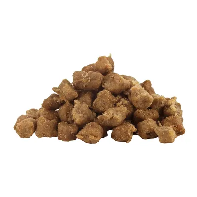 Primer plano de croquetas de pienso seco marrón y crujiente en forma de montón.