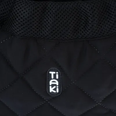 Tiaki logo on black, quilted fabric with mesh material on top.