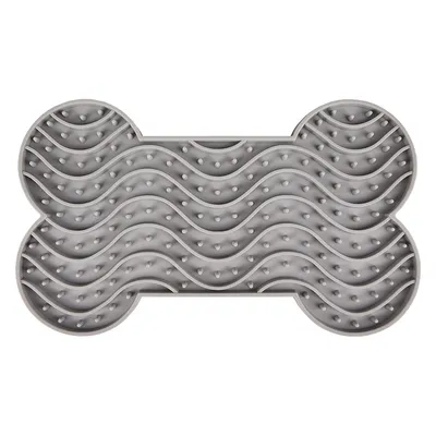 Grå slickmatta i benform med vågformade fördjupningar och knoppar.