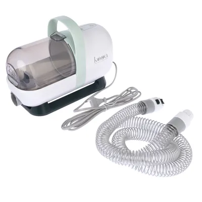 kooa pet care device with transparent container, green handle, power cable and flexible hose. Suitable for cleaning or caring for pets.