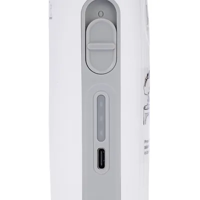 Close-up of a white device with slide switch, LED display and USB-C port. User manual partially visible.