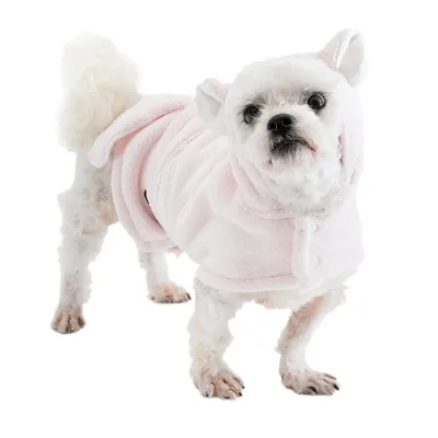 Small dog wearing a pink plush coat with hood and ears. Product shows clothing for pets.