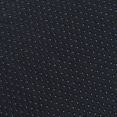 Détail de tissu noir avec surface antidérapante à picots en caoutchouc visibles, utilisé pour accessoires ou couchages pour animaux.