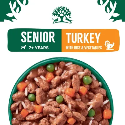 Senior turkey with rice and vegetables, suitable for 7+ years. Image shows food pieces with peas, carrots, and rice in a bowl.