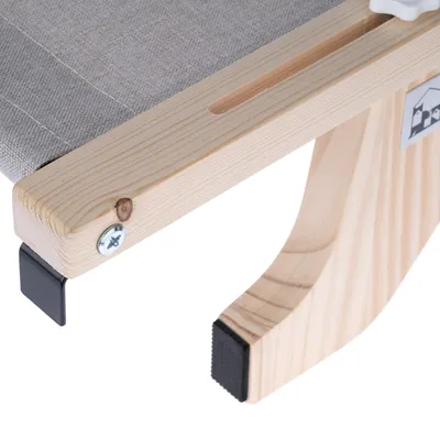 Närbild av en träram med grå tygklädsel och halkfria svarta fötter. Synlig skruv och logotyp på sidan.