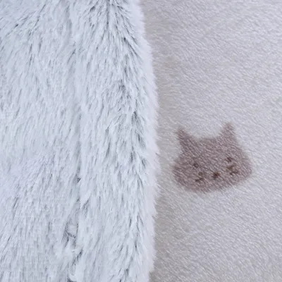 Gros plan sur deux tissus : à gauche, fausse fourrure blanche ; à droite, polaire beige avec motif tête de chat marron clair.