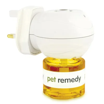 Plug-in diffuser with a bottle labelled 'pet remedy' attached, showing the product ready for use in an electrical socket.