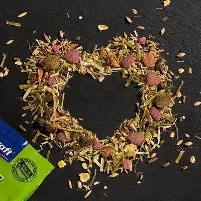 Vitakraft small animal food with natural ingredients, Made in Germany. Mix of herbs, grains and pressed heart-shaped food pieces.