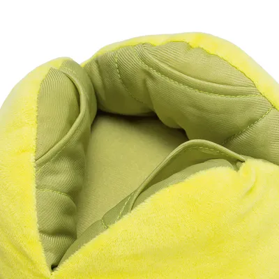 Close-up of yellow-green, padded fabric material with soft surface and stitching. Interior details visible.