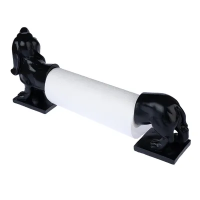 Porte-rouleau en forme de chien noir, composé de deux parties séparées tenant un rouleau d’essuie-tout blanc. Matériau visible : plastique ou résine noire brillante.