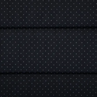 Czarny materiał z małymi, regularnymi szarymi kropkami. Odpowiedni na tapicerkę lub dekorację.