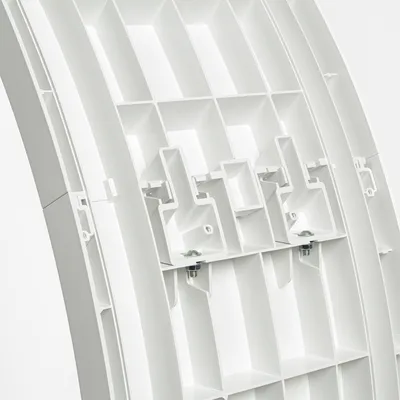 Close-up view of a white plastic structure with fastening elements and screws, suitable for technical or construction applications.
