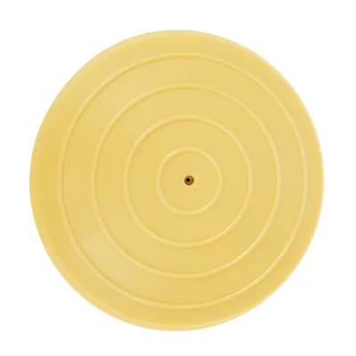 Disco di plastica giallo con cerchi concentrici e apertura centrale, possibile parte di un accessorio per animali.