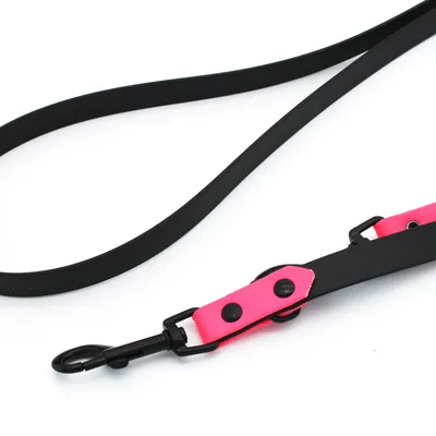 Schwarze Hundeleine mit pinken Akzenten und Metallkarabinerhaken, geeignet für Spaziergänge.