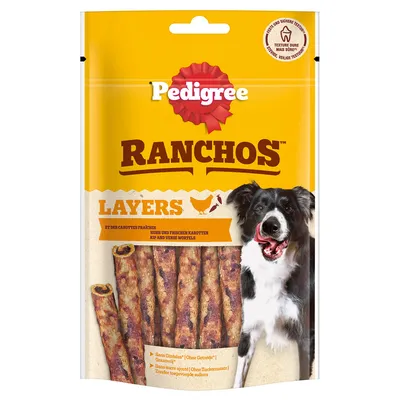 Pedigree Ranchos Layers, piščanec in sveja korenje, brez žit, brez dodanega sladkorja. Tekstura: žvečljiva in varna. Embalaža prikazuje psa in prigrizke.