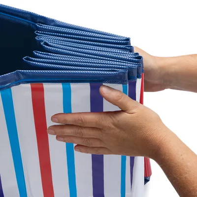 Foldable box with blue edge and colourful stripes, being folded by hands.