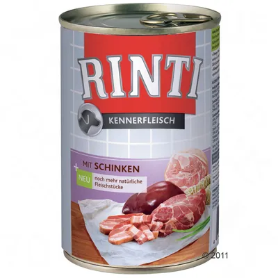 Lata de comida para perros Rinti Kennerfleisch mit Schinken. Texto visible: 'NEU noch mehr natürliche Fleischstücke'. Imagen de trozos de carne y jamón en la etiqueta.