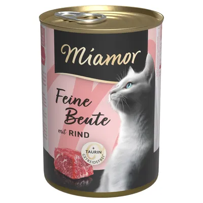 Miamor Feine Beute mit Rind, getreidefrei, enthält Taurin. Abgebildet: weisse Katze und rohes Fleischstück auf der Dose.
