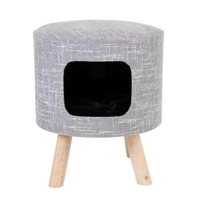 Grauer runder Hocker mit Holzbeinen und integriertem schwarzen Höhlenbereich, geeignet als Möbelstück oder Versteck.