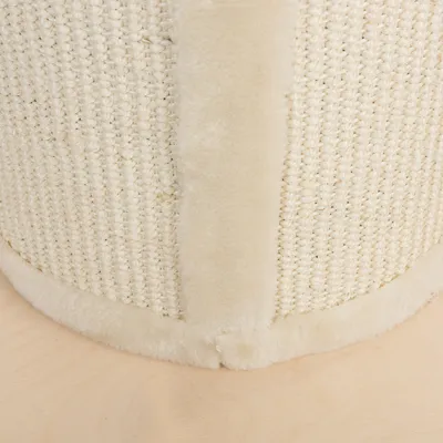 Close-up of beige scratching post material with sisal fabric and soft plush edge.