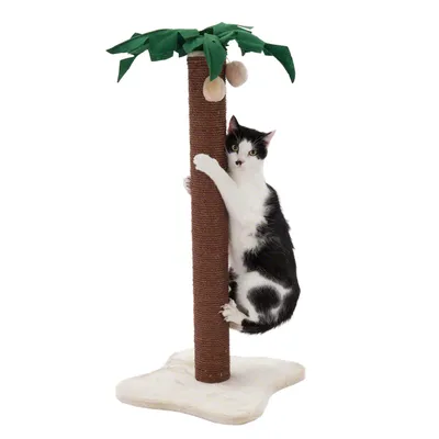 Krabpaal in de vorm van een palmboom met sisalstam, stoffen bladeren en twee hangende ballen; zwart-witte kat klampt zich vast aan de stam. Basis is wit en zacht.