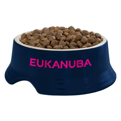 Bowl filled with dry food pellets, showing the Eukanuba brand name on the front.