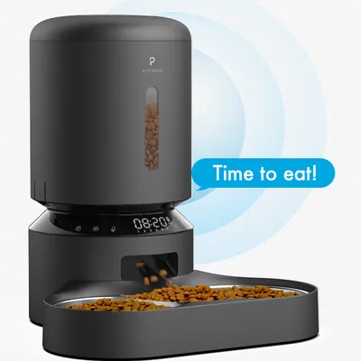 PETLIBRO automatic pet feeder dispensing dry food, digital display shows 08:20, speech bubble with visible text 'Time to eat!'. Black plastic material.