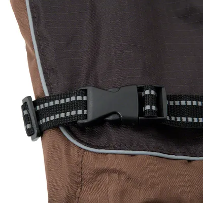 Close-up of a black snap fastener with reflective stripe on brown fabric.