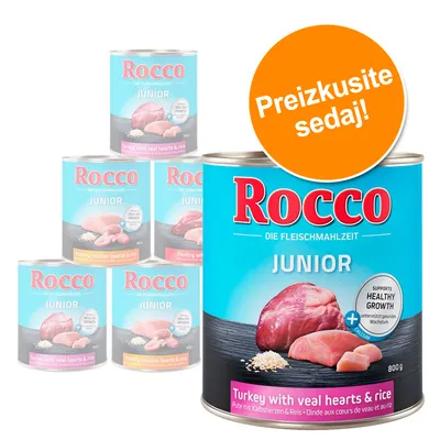 Konzerva Rocco Junior, puran s telečjimi srčki in rižem, 800 g. Na embalaži: 'SUPPORTS HEALTHY GROWTH', 'Preizkusite sedaj!'. Več okusov v ozadju.