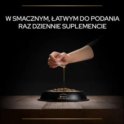 Ręka polewa karmę w misce Purina Pro Plan płynnym suplementem. Widoczny tekst: W smacznym, łatwym do podania raz dziennie suplemencie.