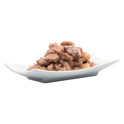 Krupan prikaz posluženog mokrog hrane na bijelom tanjuru, smeđi komadići mesa u umaku.