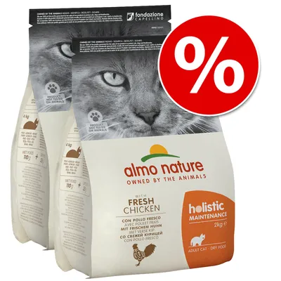 Две опаковки Almo Nature Holistic Maintenance с прясно пиле, 2 кг, за котки. Видим е надпис „Product not tested on animals“. Червен кръг с бял процентен знак за промоция. Две опаковки Almo Nature Holistic Maintenance с прясно пиле, 2 кг, за котки. Видим е надпис „Product not tested on animals“. Червен кръг с бял процентен знак за промоция.