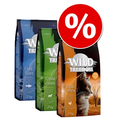 Trzy opakowania karmy Wild Freedom dla kotów: Wide Country 2 kg, Green Lands 2 kg, Cold River 2 kg. Widoczny znak procentowy informujący o promocji.