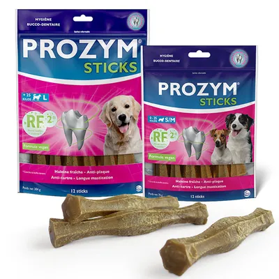 Prozym Sticks for dogs, vegan, available in sizes S/M and L. Supports fresh breath, anti-plaque, anti-tartar, and long chewing time. Packaging shows dogs and dental care symbol.