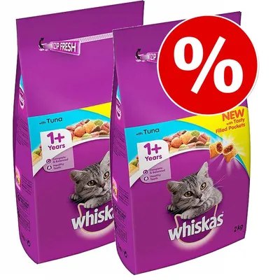Two 2kg Whiskas cat food bags with tuna, for cats 1+ years. Visible text: 'Complete & balanced', 'Healthy teeth', 'NEW with Tasty Filled Pockets'. Large red percent symbol in corner.