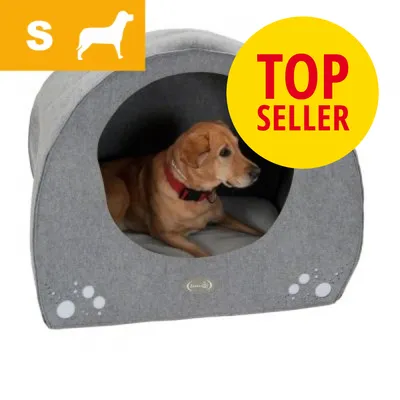 Hund i grå hundehule med pude, mærket 'TOP SELLER' og ikon for størrelse S øverst til venstre. Materiale ligner stof. Ingen synlige produkt- eller brandnavne.