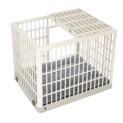 Cage rectangulaire en plastique beige avec grille sur le dessus et coussin gris à l’intérieur, vue ouverte sans porte visible.