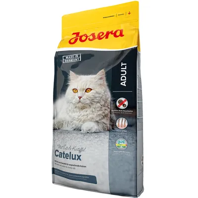 Опаковка Josera Catelux Adult за котки, с изображение на бяла котка. Видими текстове: Made in Germany, Extrem Anti-Haarballen, Haut & Fell, pH 6,0–6,5, Mit Ente & Kartoffel.