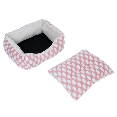 Roze huisdierenbed met wit stippenpatroon en uitneembaar kussen, zwarte binnenkant, zachte vulling.